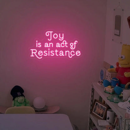 Joy is an act resistance neon sign