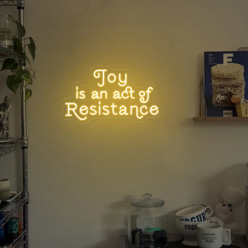 Joy is an act resistance neon sign